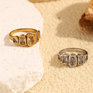Detailed shot of gold and silver vintage rings with oval and baguette zircons on stone
