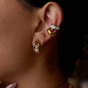 Luxury gold stainless steel earrings with sparkling cubic zirconia on female model