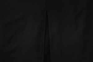 Close-up of side slit design and double-row stitching on black sleeveless dress