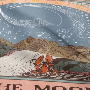 Close-up of woven fabric texture with tarot moon phase and celestial pattern detail