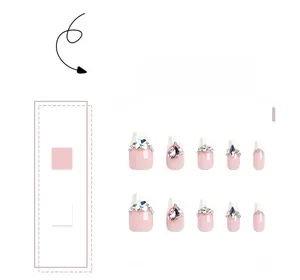 Detailed view of French press-on nails with pink heart gems and sparkling rhinestones