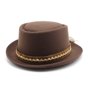 Vintage brown wool pork pie hat with woven band for men and women on white background