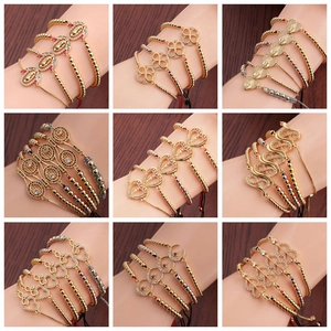 Detail view of adjustable zircon evil eye beaded bracelets in gold and rose gold finishes