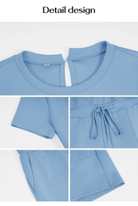 Detail view of light blue cotton romper featuring round neck and adjustable drawstring waist