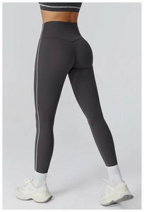 Close-up back view of high waisted gray yoga leggings with white side stripe