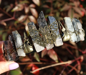 Detail of a handmade crystal crown featuring a bronze butterfly and small skulls