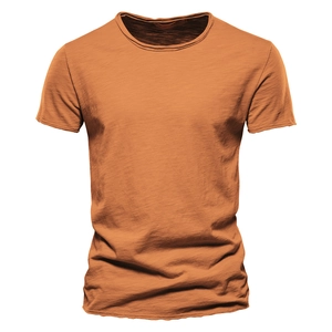 Close-up of orange slub cotton texture and round neckline on men's slim fit T-shirt