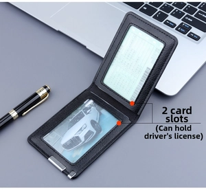 Detail of ultra-slim black leather card holder with dual transparent slots and metal clip