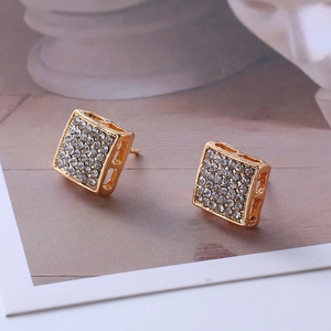 Detail of square gold-tone stud earrings featuring rows of shimmering micro-pavé crystals