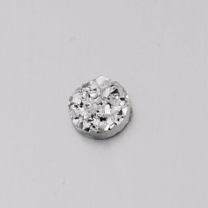 Detailed view of a 6mm round resin sparkling druzy bead with silver foil texture for DIY crafts