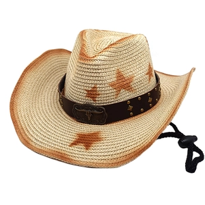 Detail of straw cowboy hat featuring metal bull head buckle and star print brim