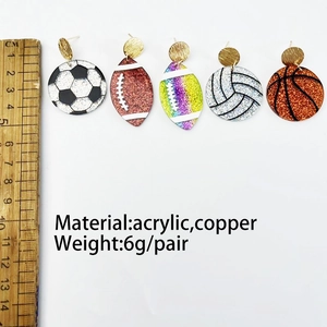 Detail view of 6g sports acrylic earrings featuring football and basketball motifs