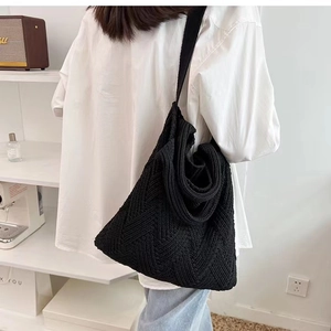 Black woven knit tote bag with geometric patterns for casual commuting use