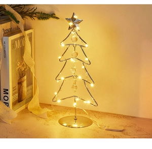 Close-up of golden metal LED Christmas tree with crystal pendants and warm lights