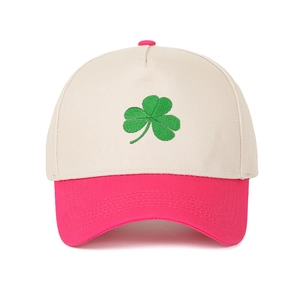 Close-up of green clover embroidery and stitching on a two-tone trucker baseball cap