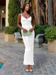 Detailed view of the sparkling white sequin fabric and sleek v-neck strap on a slim gown