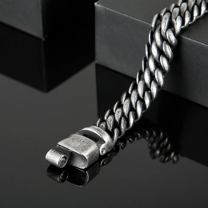 Detail of vintage silver mesh stainless steel bracelet with robust mechanical clasp