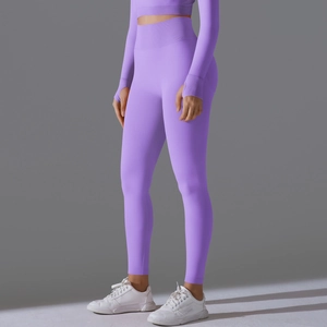 Detailed side view of high-waist purple seamless yoga leggings and long sleeve gym top set