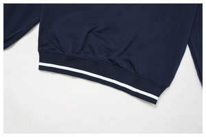Détail du bord-côte bleu marine du sweat-shirt avec une rayure blanche contrastée