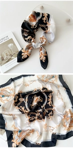 Detail of baroque silk scarf with black white and gold chain patterns shown on prop book