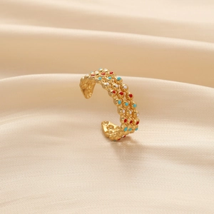 Gold hollow open ring with colorful enamel dots on champagne silk background
