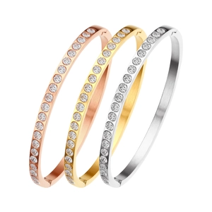 Three minimalist stainless steel bangles with sparkling zircon in rose gold, gold and silver