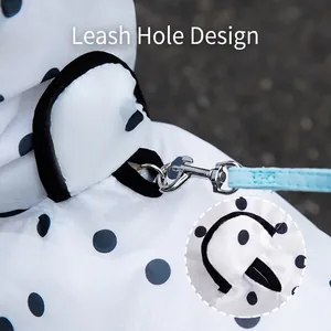 Waterproof white polka dot dog raincoat with a built-in leash hole for outdoor walking