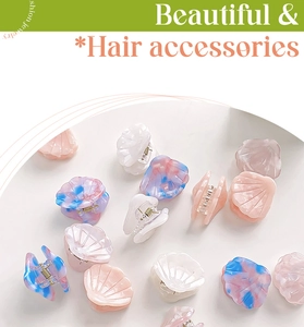 Mini shell-shaped acetate hair claws in pastel marble and solid colors for girls
