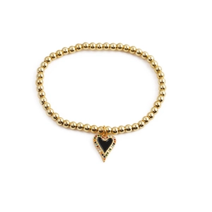 Detailed shot of golden bead bracelet with black enamel heart pendant and zircon inlay