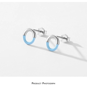 Detailed view of 925 sterling silver geometric earrings with sky blue enamel finish