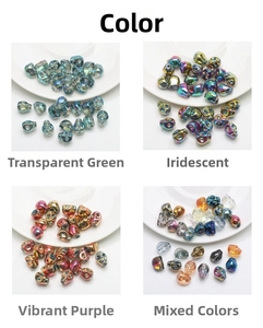 Macro display of skull-shaped glass beads in green, purple, and iridescent finishes