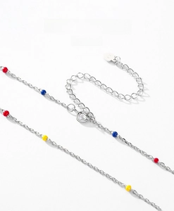 Macro shot of S925 sterling silver chain with colorful enamel beads and lobster clasp
