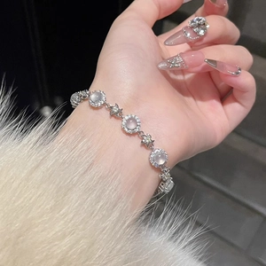 Elegant silver chalcedony bracelet with zircon star charms on female wrist