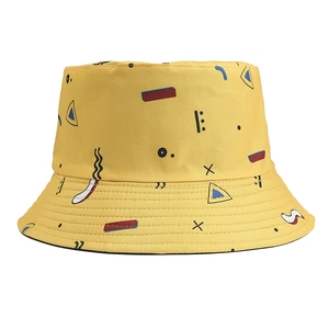 Detail view of cotton bucket hat with vibrant geometric prints and yellow fabric texture