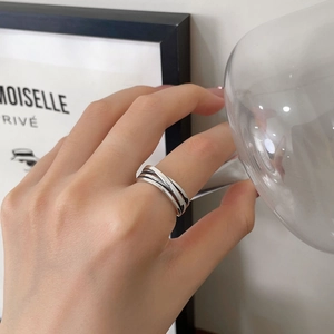 Detail of s925 sterling silver multilayer irregular ring on finger with vintage oxidized finish