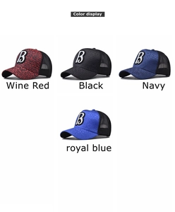 Detail view of retro baseball caps featuring letter B patch and colorful mesh back panels