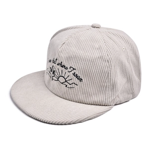 Macro detail of black cactus embroidery and lettering on beige corduroy flat brim cap
