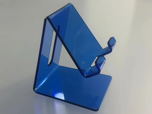 Side view of clear blue acrylic phone stand with polished finish for desk
