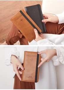 Detail view of brown and black leather passport wallets with secure elastic straps