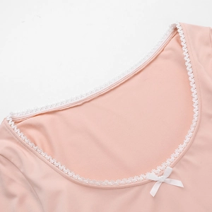 Detail of square neckline with white lace trim and bow on pink long sleeve top