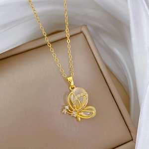 Elegant gold butterfly pendant necklace with opal wings on premium silk background