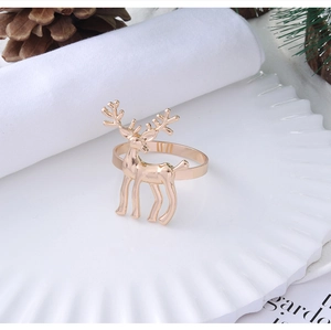 Detailed close-up of golden reindeer metal napkin ring on a festive holiday table