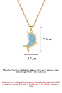 Macro view of blue dolphin pendant with white zircon insets and titanium steel gold chain