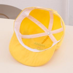 Detail view of the lightweight yellow baby sun hat interior with soft sweatband and lining