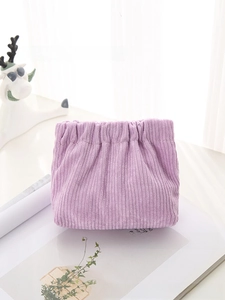 Detail of light purple corduroy storage pouch with drawstring and ribbed texture finish