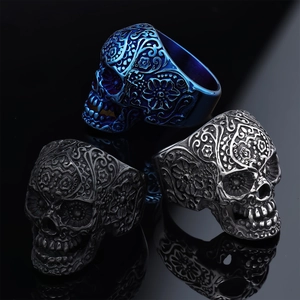 Gothic skull rings in blue, black, and silver with detailed floral engraving textures