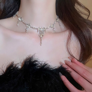 Elegant silver rhinestone fringe necklace with teardrop pendant worn by a model