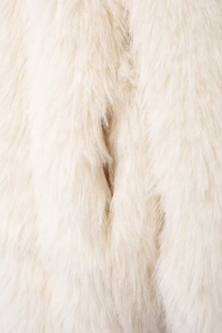 Detailed macro view of plush white faux fur texture showing soft and long fibers