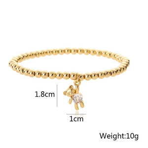 Detail view of a 10g gold beaded bracelet with a 1.8cm x 1cm zircon bear pendant