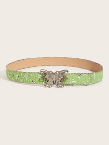 Close-up of sparkling silver sequin fabric belt with a large metal butterfly buckle